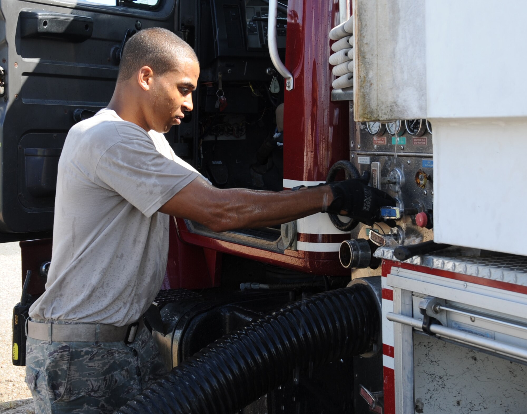 Senior Airman Chris Larry, 2nd Civil Engineer Squadron firefighter, drains air out of a line on Barksdale Air Force Base, La., Aug. 12, 2013. Air must be removed from the line to ensure it is ready to go in the event of a fire. (U.S. Air Force photo/Senior Airman Sean Martin)