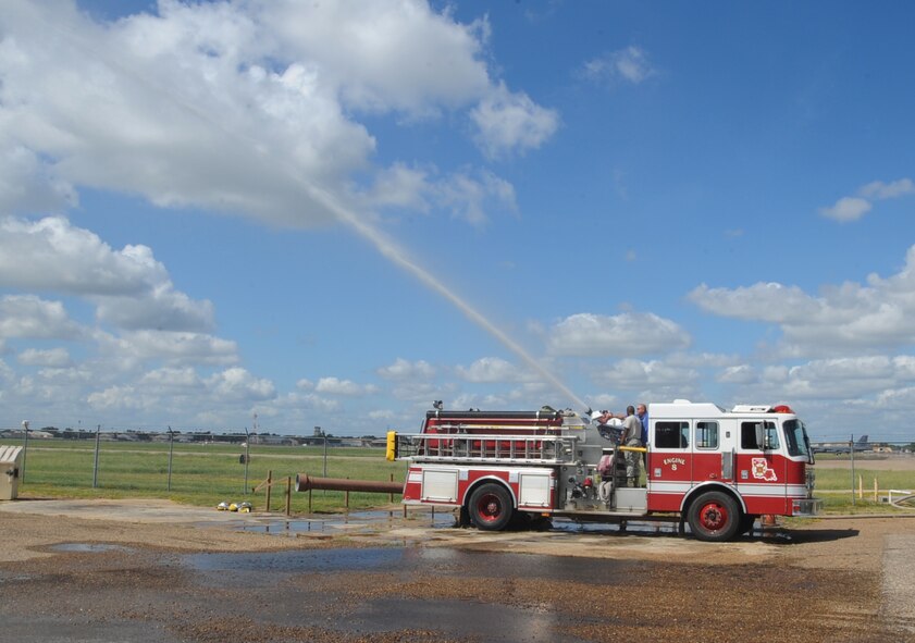 Firefighters from the 2nd Civil Engineer Squadron conduct drafting training on Barksdale Air Force Base, La., Aug. 12, 2013. This exercise trained Airmen to find, collect and use water without a hydrant. (U.S. Air Force photo/Senior Airman Sean Martin)