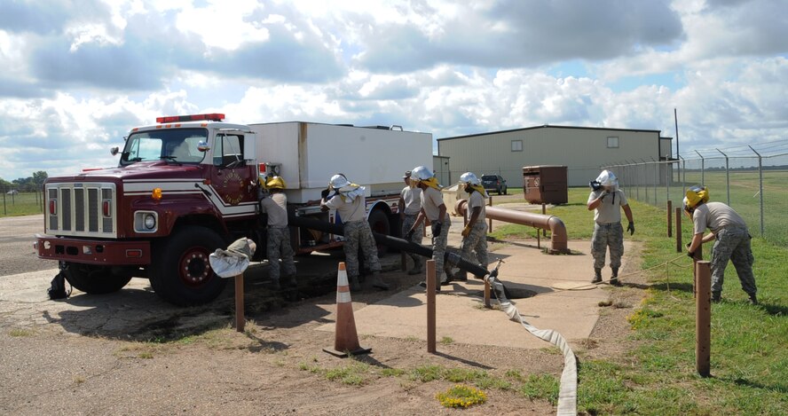 Airmen from the 2nd Civil Engineer Squadron Fire Department conduct drafting training on Barksdale Air Force Base, La., Aug. 12, 2013. Drafting is the process of taking water from a source such as a lake, river, pool or pond to fill up trucks if no hydrant is available. (U.S. Air Force photo/Senior Airman Sean Martin)