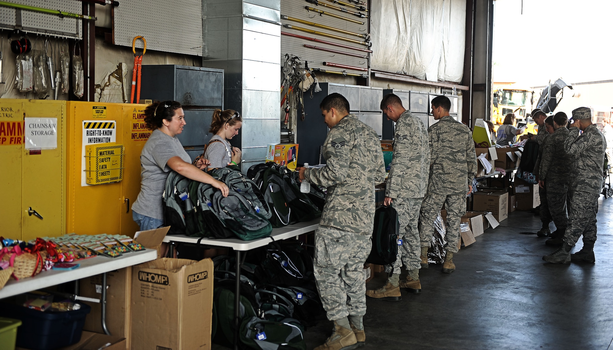 Members of the 375th Civil Engineer Squadron takes items that was donated by Operations Heroes Aug. 9, 2013 at Scott Air Force Base, Ill.  Operation Hero donated clothes, school supplies, diapers, bookbags, and other baby items. (U.S. Air Force photo/Senior Airman Divine Cox)