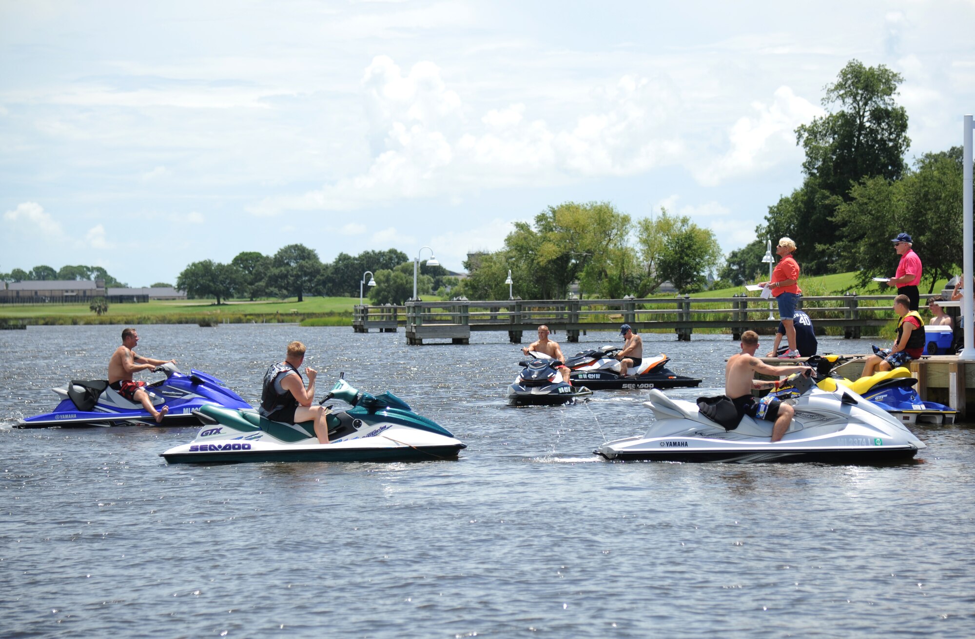 Prizes are awarded to the winners of the jet ski races as participants rest on their jet skis in the Biloxi Back Bay behind Bayridge housing, at Keesler Air Force Base, Miss., Aug. 10, 2013.  There were 10 participants in the Keesler Outdoor Recreation sponsored event.  (U.S. Air Force photo by Kemberly Groue)