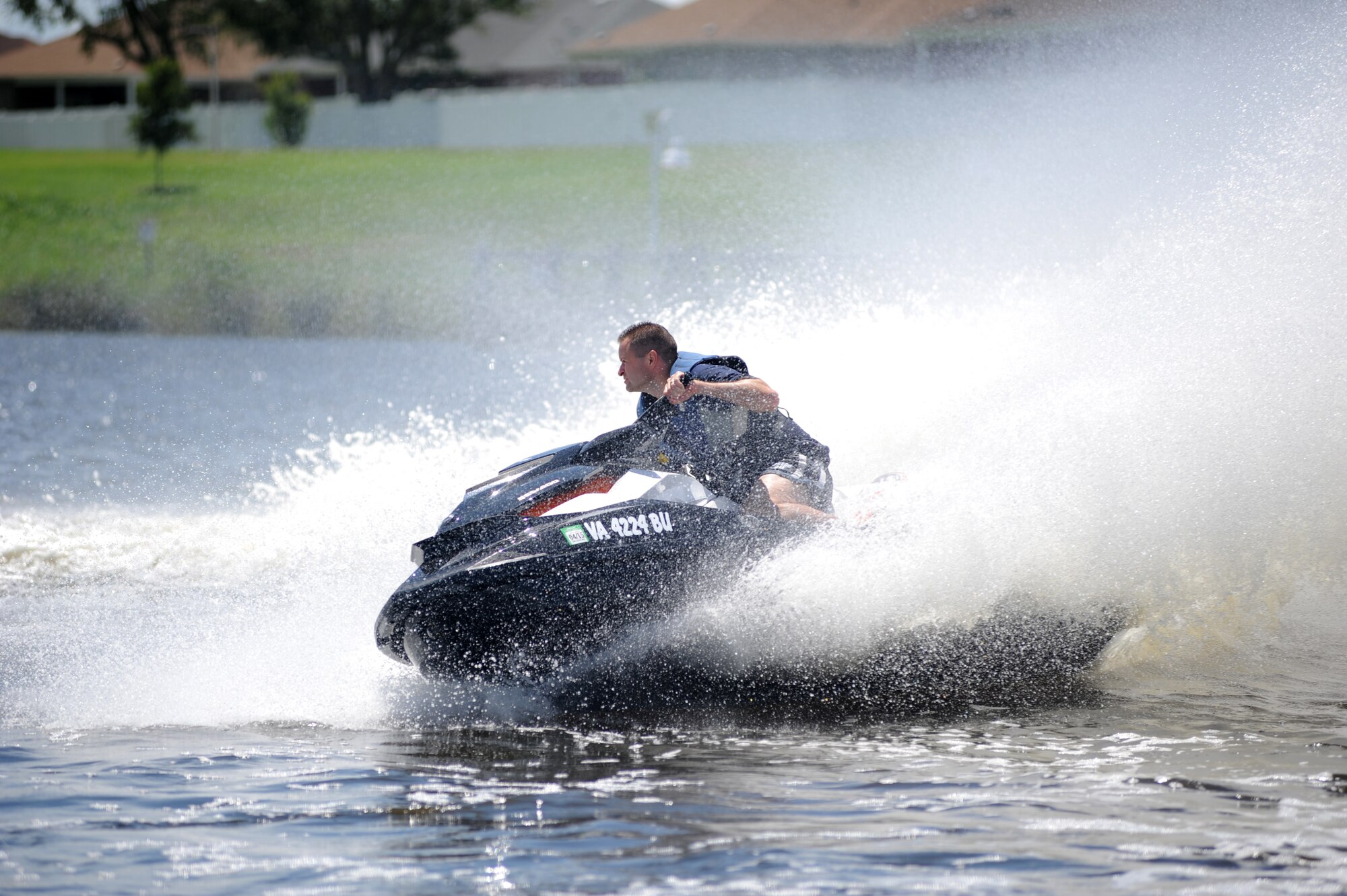 Lt. Col. Brandon Hart, 81st Training Wing, takes a turn as he makes his way around a buoy to complete the first of two races with a time of 51 seconds during a jet ski race in the Biloxi Back Bay behind Bayridge housing, at Keesler Air Force Base, Miss., Aug. 10, 2013. There were 10 participants in the Keesler Outdoor Recreation sponsored event.  (U.S. Air Force photo by Kemberly Groue)