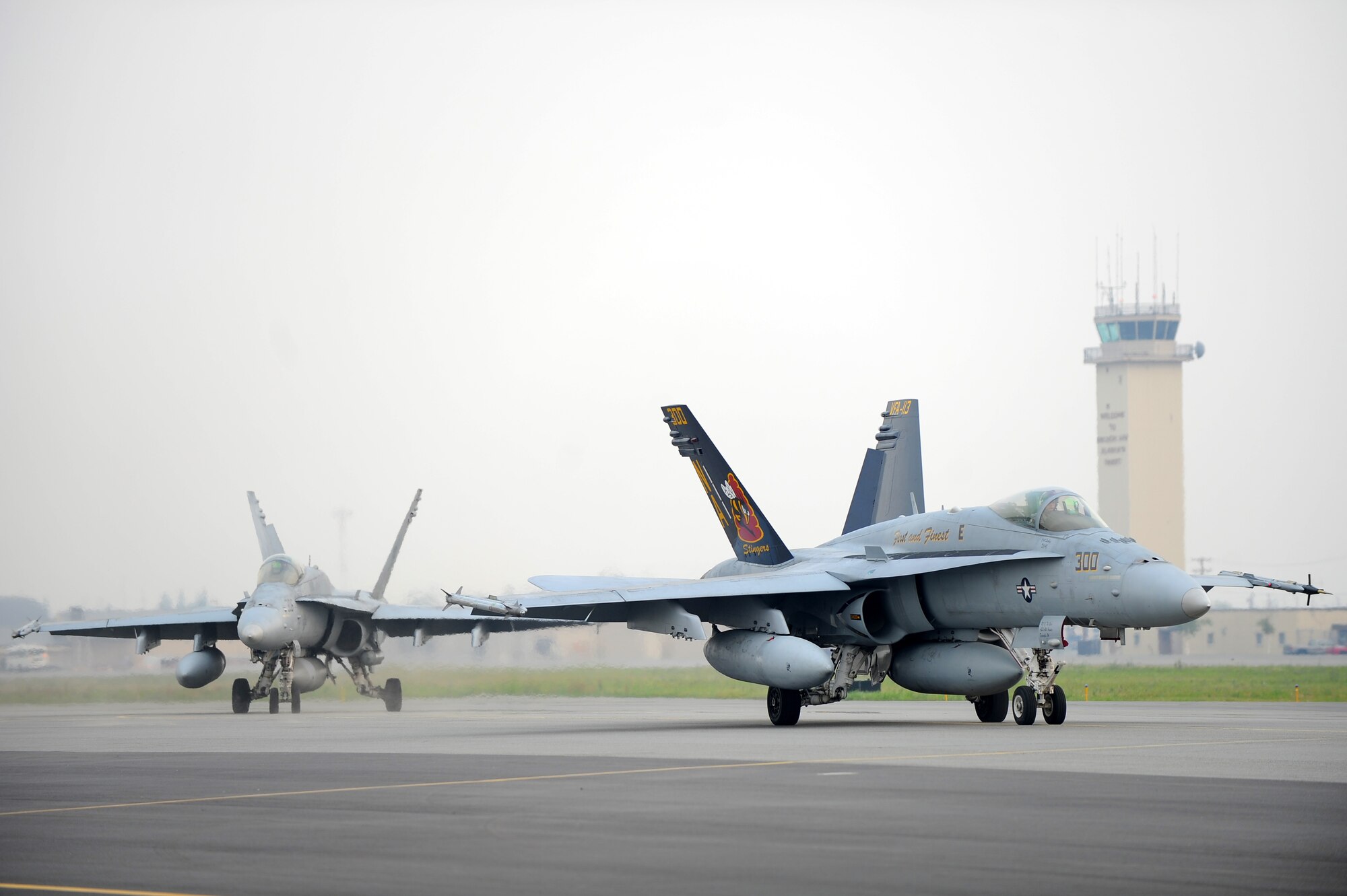 U.S. Navy F/A-18 Hornets assigned to Strike Fighter Squadron 113, Naval Air Station Lemoore, Calif., taxi on the runway during RED FLAG-Alaska 13-3 Aug. 9, 2013, Eielson Air Force Base, Alaska.  The F/A-18 is used primarily as a fighter escort and for fleet air defense. In its attack mode, it is used for force projection, interdiction, and close and deep air support. (U.S. Air Force photo by Staff Sgt. Jim Araos/Released)
