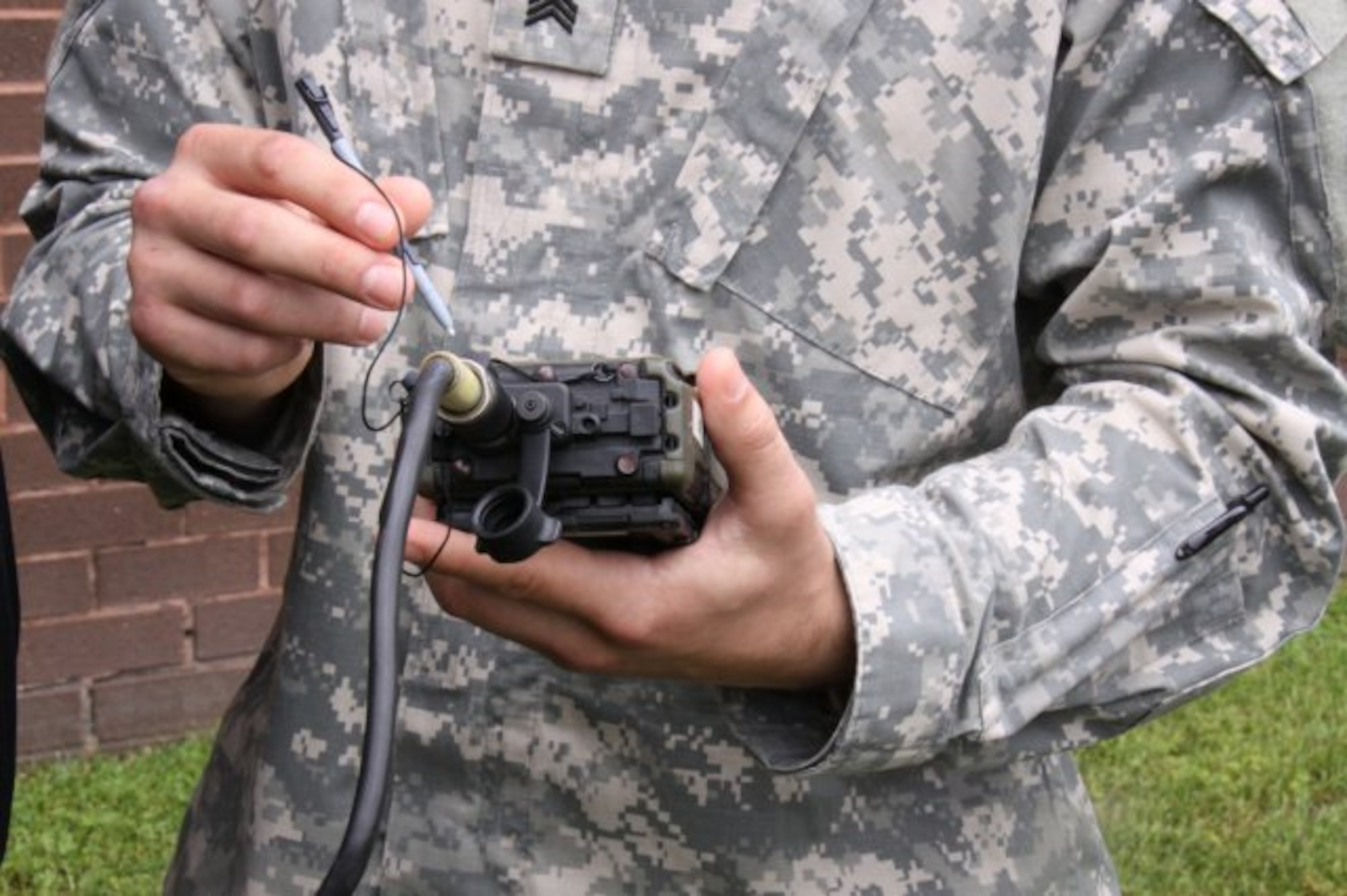 A Soldier tries out a Simple Key Loader (SKL), fielded by Project Director Communications Security, known as PD COMSEC, at Aberdeen Proving Ground, Md. PD COMSEC is in the process of replacing the SKL with a Next Generation Load Device, which will be nearly half the size and have more capabilities and features. (Courtesy Photo)