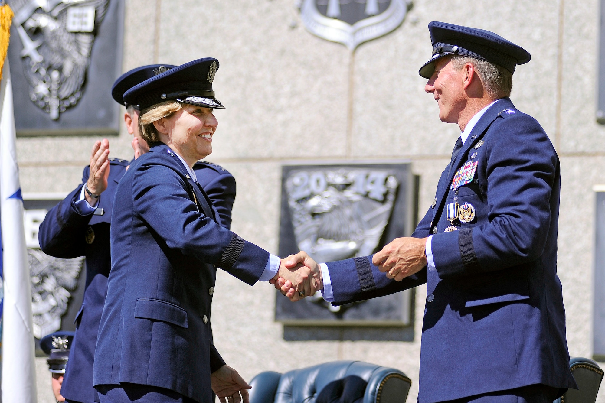 Lt. Gen. Michelle Johnson (left) shakes hands with Lt. Gen. Mike Gould after being recognized as the superintendent of the Air Force Academy during the change of command cermony Aug. 12, 2013. (U.S. Air Force photo/Sarah Chambers)