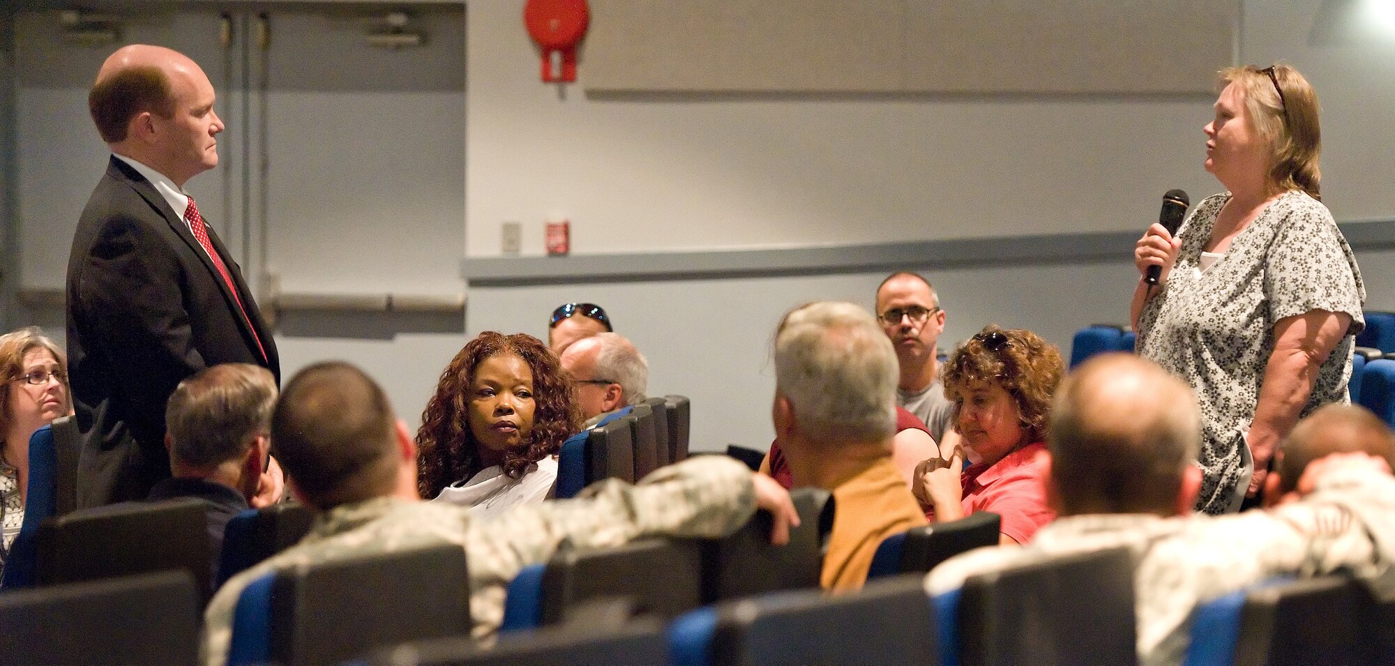 Bonnie Knox, 436th Medical Group commander?s secretary, speaks to U.S. Sen. Chris Coons of Delaware at a townhall meeting Aug. 8, 2013 at the base theater on Dover Air Force Base, Del. Knox told Coons that the current sequester and furloughs disappoint her. (U.S. Air Force photo/Roland Balik)


