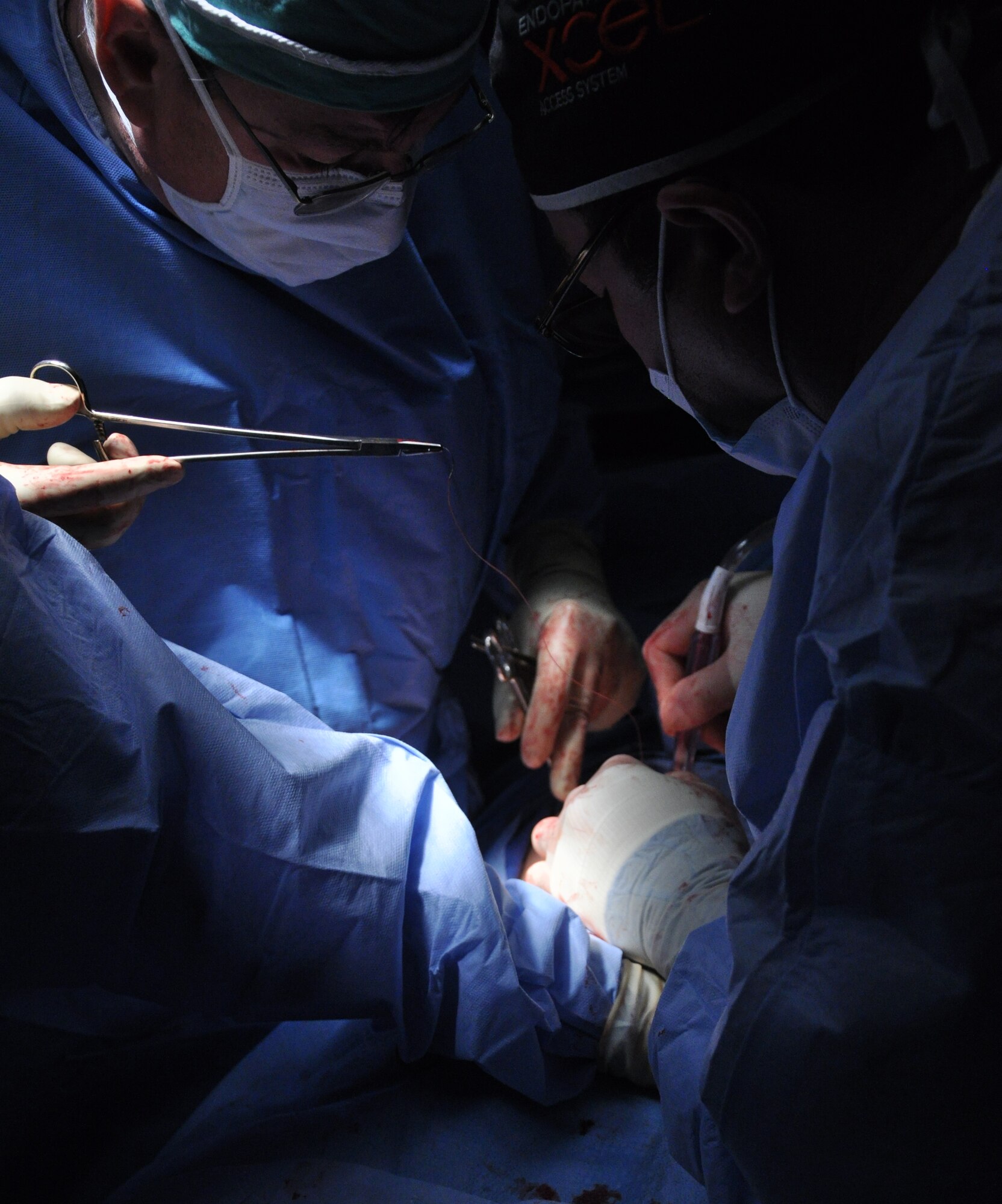 As part of a six-person mobile surgical team from Joint Task Force-Bravo U.S. Army Col. Ronald Rene, Medical Element general surgeon uses sutures to close an incision after completing a gallbladder removal with an Honduran surgeon Aug. 7, 2013 at a hospital in Comayagua, Honduras.  The surgical team assisted the hospital in removing three gallbladders and one bot fly larvae from a child’s body. MEDEL provides relevant, responsive care while enhancing the capabilities of partner nations.