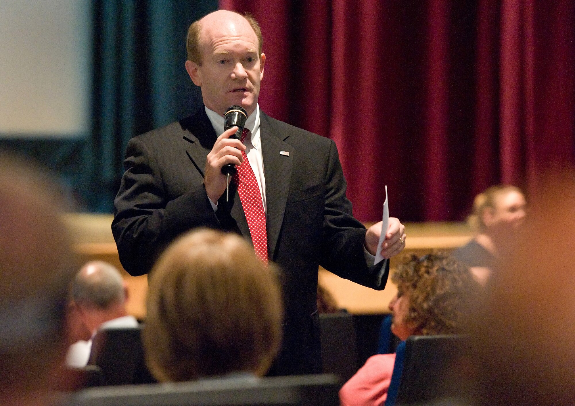 U.S. Sen. Chris Coons of Delaware speaks at a townhall meeting Aug. 8, 2013, at the base theater on Dover Air Force Base, Del. Coons spoke with Team Dover civilian employees about the impact of the furlough on their personal lives. (U.S. Air Force photo/Roland Balik)