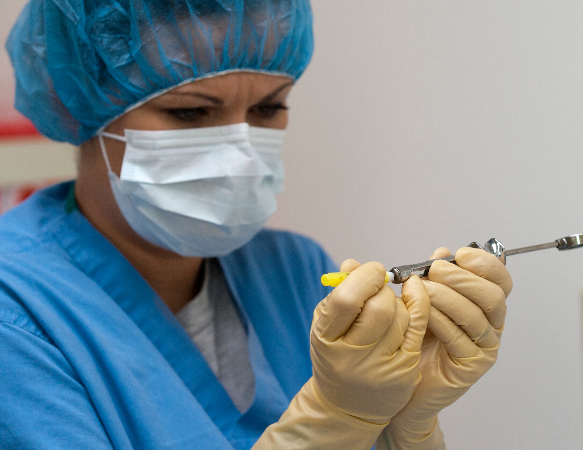 U.S. Air Force Tech. Sgt. Jaime Meadows-Valley, 366th Aerospace Medicine Squadron dental support element and dental logistics NCO in charge, places a cap on a needle Aug. 8, 2013, at Mountain Home Air Force Base, Idaho. The caps are safety precautions to keep instruments sterile before surgery. (U.S. Air Force Photo by Airman 1st Class Brittany A. Chase/Released)