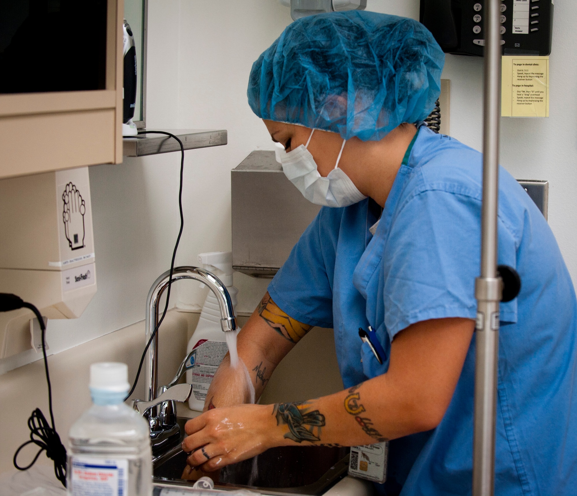U.S. Air Force Tech. Sgt. Jaime Meadows-Valley, 366th Aerospace Medicine Squadron dental support element and dental logistics NCO in charge, thoroughly washes her hands before putting on non-latex gloves to maintain a sterile environment while setting up for a surgical procedure Aug. 8, 2013, at Mountain Home Air Force Base, Idaho. Maintaining sterile instruments is key to ensuring patient safety. (U.S. Air Force Photo by Airman 1st Class Brittany A. Chase/Released)