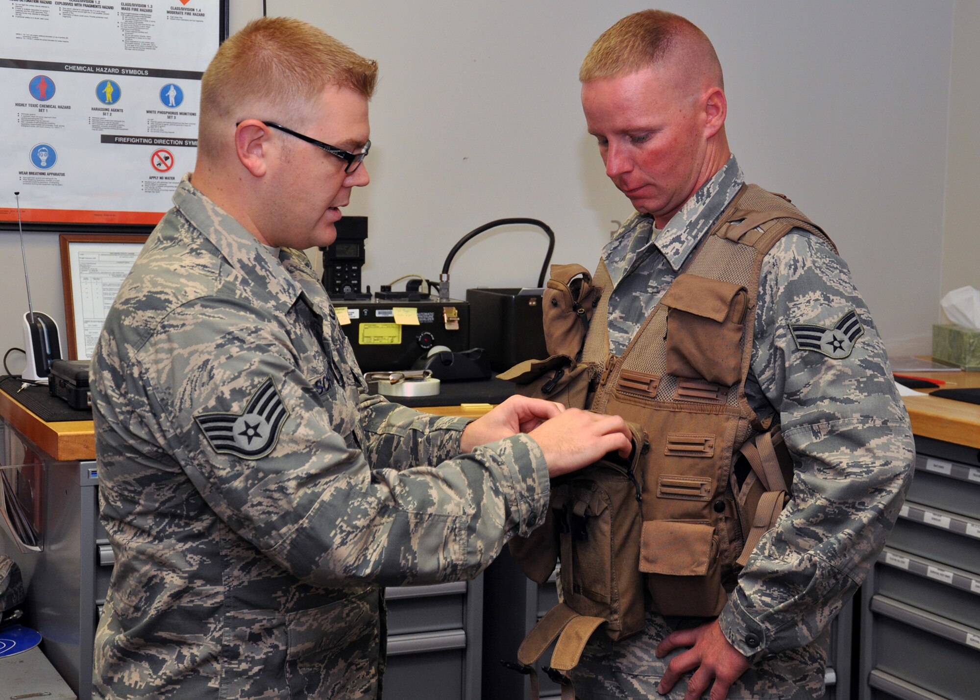 WRIGHT-PATTERSON AIR FORCE BASE, Ohio - Staff Sgt. Austin Schutte, 445th Operations Support Squadron aircrew flight equipment technician, shows Senior Airman Zachary Simon, 445th Logistics Readiness Squadron materiel management journeyman, the contents of a survival vest during the July 13 89th Airlift Squadron hosted job swap.  Job swap allows 445th reservists the opportunity to learn what other units do in the wing and how everyone plays a key role in the wing’s overall mission. (U.S. Air Force photo/Senior Airman Matthew Cook)