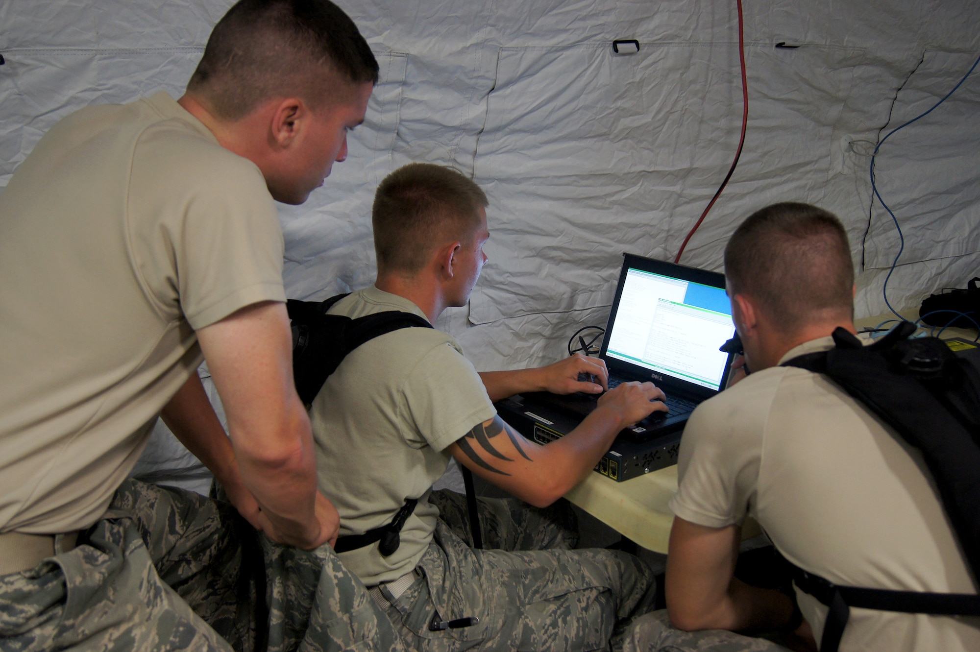 Members of the 35th Combat Communications Squadron, Tinker Air Force Base, Okla., hone their skill during a field training exercise at the Lackland AFB Media Annex in San Antonio, Texas. The 35th CBCS is one of four Reserve combat communications squadrons located in separate regions of the country that provide theater-deployable communications during wartime and contingency operations or humanitarian missions in austere locations.
