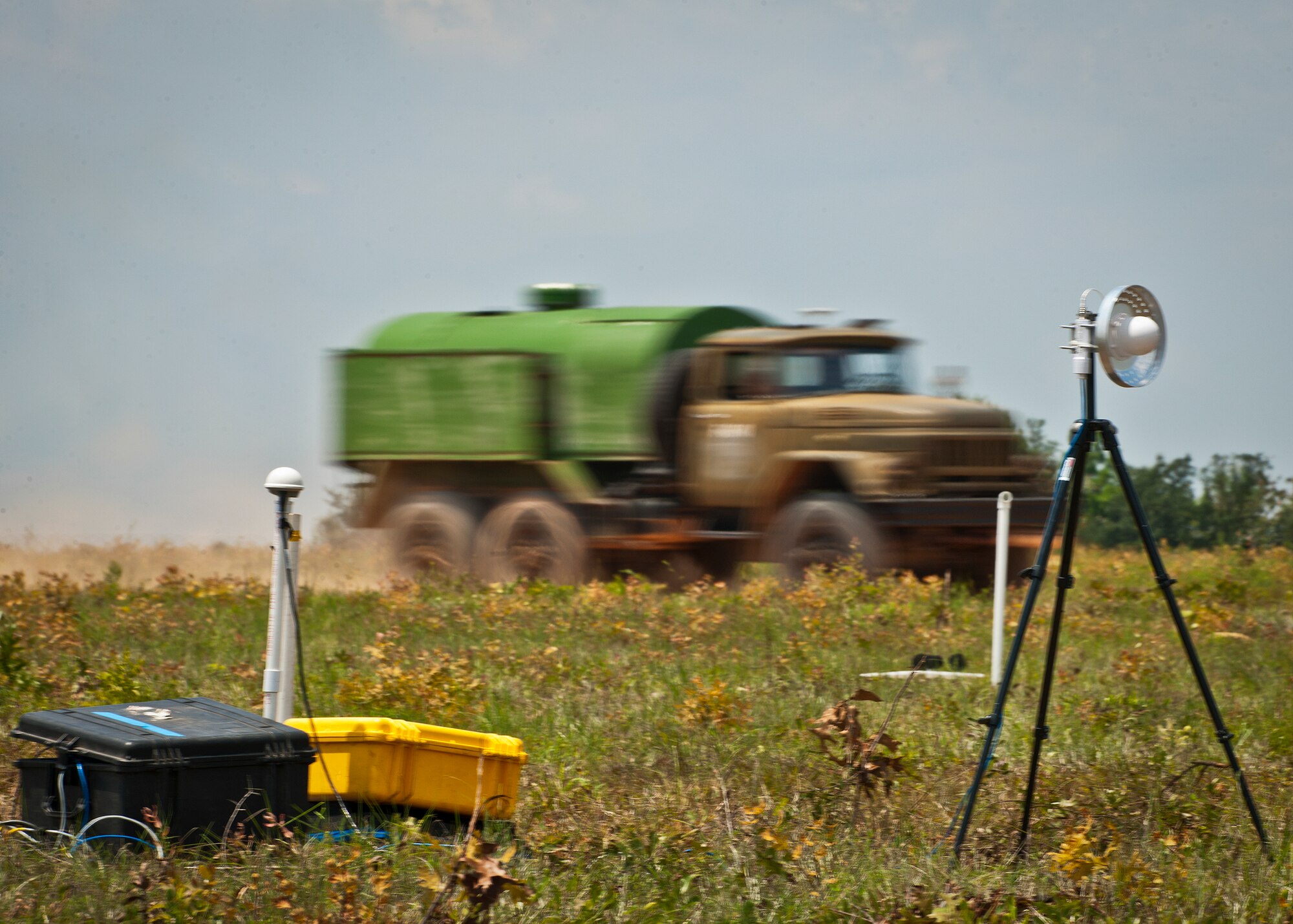 A military vehicle rushes by recording equipment set up to collect all sound data emitted from the truck during Acoustic Week Aug. 6 at Eglin Air Force Base, Fla. The event is a three-week project hosted by the 46th Test Squadron and Project Chicken Little.  It is a cost-shared opportunity between the government and customers to collect specific and general sound data from ground and aerial vehicles.  The event began July 29 and ends Aug. 15.  (U.S. Air Force photo/Samuel King Jr.)