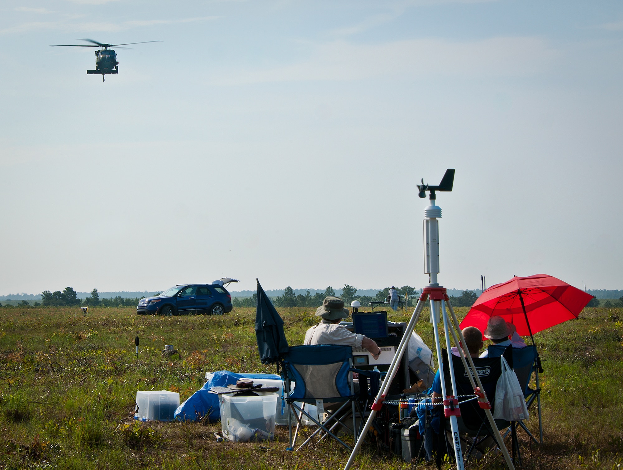 An Army UH-60 Blackhawk approaches Northrop Grumman personnel who are recording the various sounds emitted by the helicopter during Acoustic Week Aug. 6 at Eglin Air Force Base, Fla.  The Blackhawk passed over the sound equipment at different speeds and altitudes to provide unique acoustic variations to be recorded.  The event is a three-week project hosted by the 46th Test Squadron and Project Chicken Little.  It is a cost-shared opportunity between the government and customers to collect specific and general sound data from ground and aerial vehicles.  The event began July 29 and ends Aug. 15.  (U.S. Air Force photo/Samuel King Jr.)