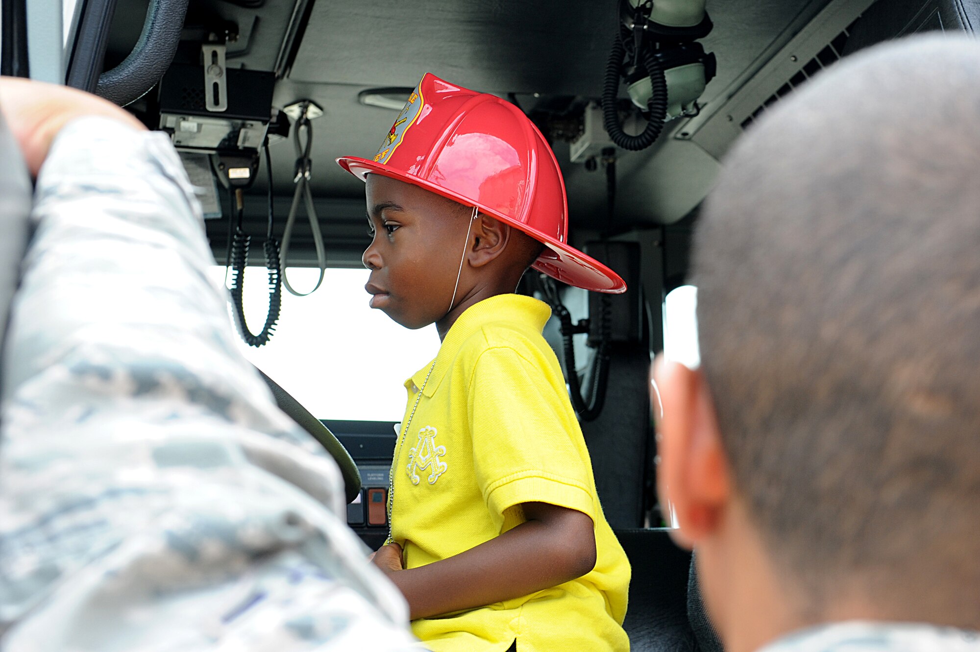 Christian Mooring takes the wheel in a fire truck during Operation Hero at Langley Air Force Base, Va., August 7, 2013. Langley's fire department was one of many units who participated in the event. (U.S. Air Force photo by Airman 1st Class Kimberly Nagle/Released)