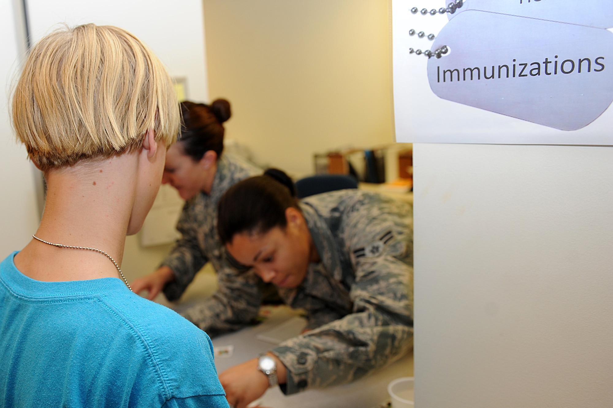 Austin Jenkins waits for simulated immunizations while participating in Operation Hero at Langley Air Force Base, Va., Aug. 7, 2013. The events included various displays and presentations, giving children a view of the different career fields involved in the pre-deployment process.  (U.S. Air Force photo by Airman 1st Class Kimberly Nagle/Released)