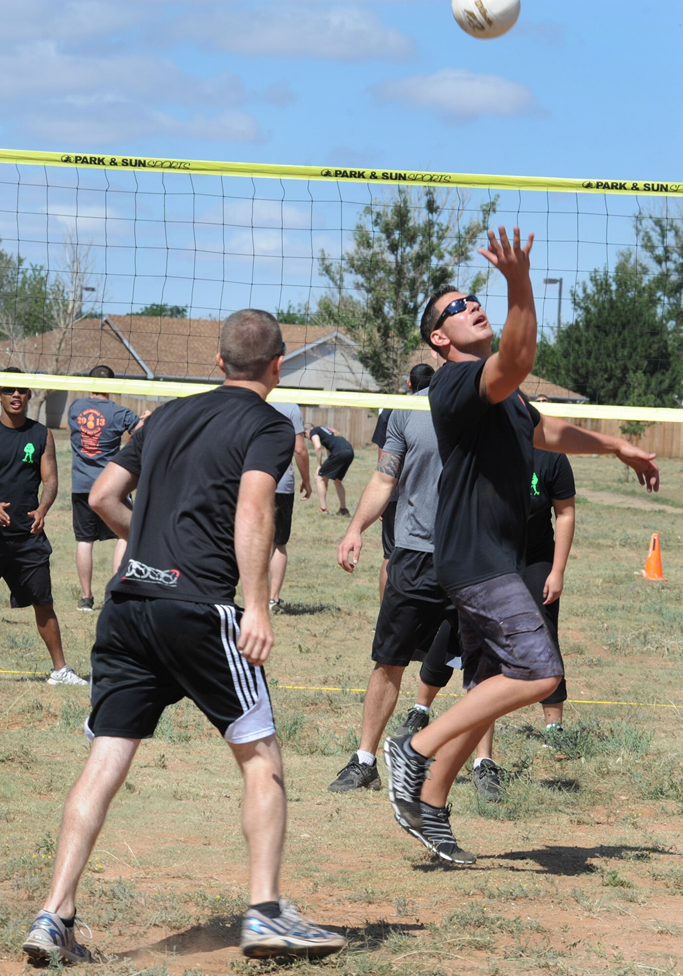 Members of the 27th Special Operations Maintenance Squadron play a game of volleyball during the Weapons and Ammo competition Aug. 9, 2013 at Cannon Air Force Base, N.M. The competition was a daylong event with games and activities for military members and their families. (U.S. Air Force photo/Senior Airman Ericka Engblom)

