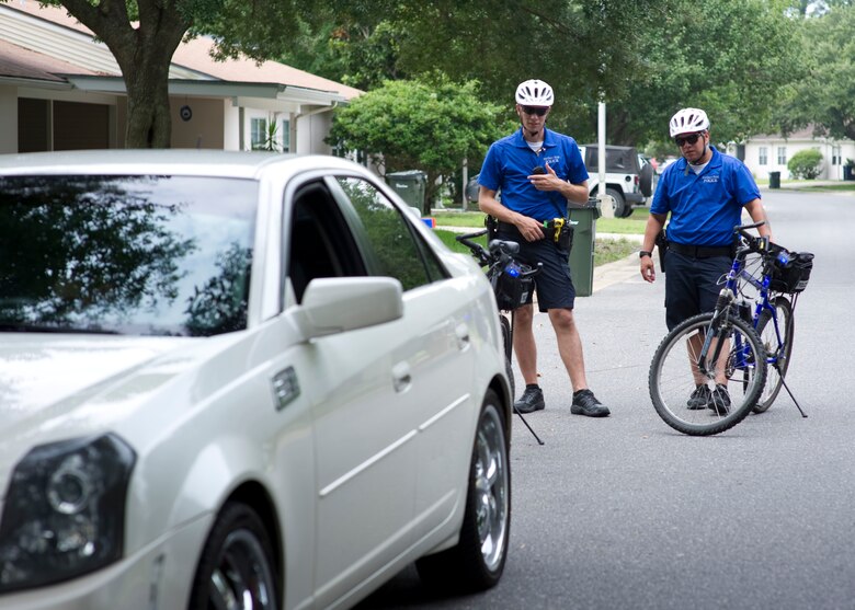 Airman 1st Class Gary Jackson and Senior Airman Pablo Uribe, bike patrolmen with 1st Special Operations Security Forces Squadron, perform a traffic stop in base housing on Hurlburt Field, Fla. July 24, 2013. The bike patrols perform the same duties and responsibilities as other vehicle based patrol units. 
(U.S. Air Force Photo/ Staff Sgt. John Bainter)

