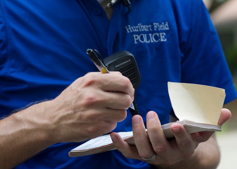 Airman 1st Class Gary Jackson, a bike patrolman with 1st Special Operations Security Forces Squadron, writes a citation during a traffic stop in base housing on Hurlburt Field, Fla. July 24, 2013. The bike patrols give 1st SOSFS the advantage of being unobtrusive and the ability to travel places where vehicles cannot. 
(U.S. Air Force Photo/ Staff Sgt. John Bainter)
