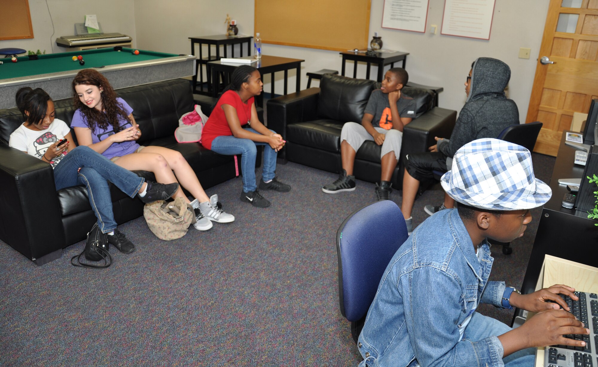 Members of the Keystone Club Teen Council meet July 26 to discuss upcoming events at the Luke Air Force Base Youth Center. The council is a teen character building and citizenship program enabling members to network and resolve issues impacting military teens. (U.S. Air Force photo/Staff Sgt. Luther Mitchell)