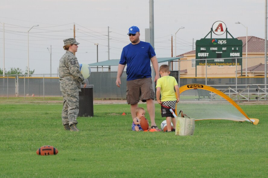 Master Sgt. Romney Scheirer, 56th Fighter Wing Chapel superintendent, and her family take advantage of the sports equipment provided for the event. Stars Soccer and Sports program representatives provided sports equipment for children to play with. (U.S. Air Force photo/Airman 1st Class Pedro Mota)