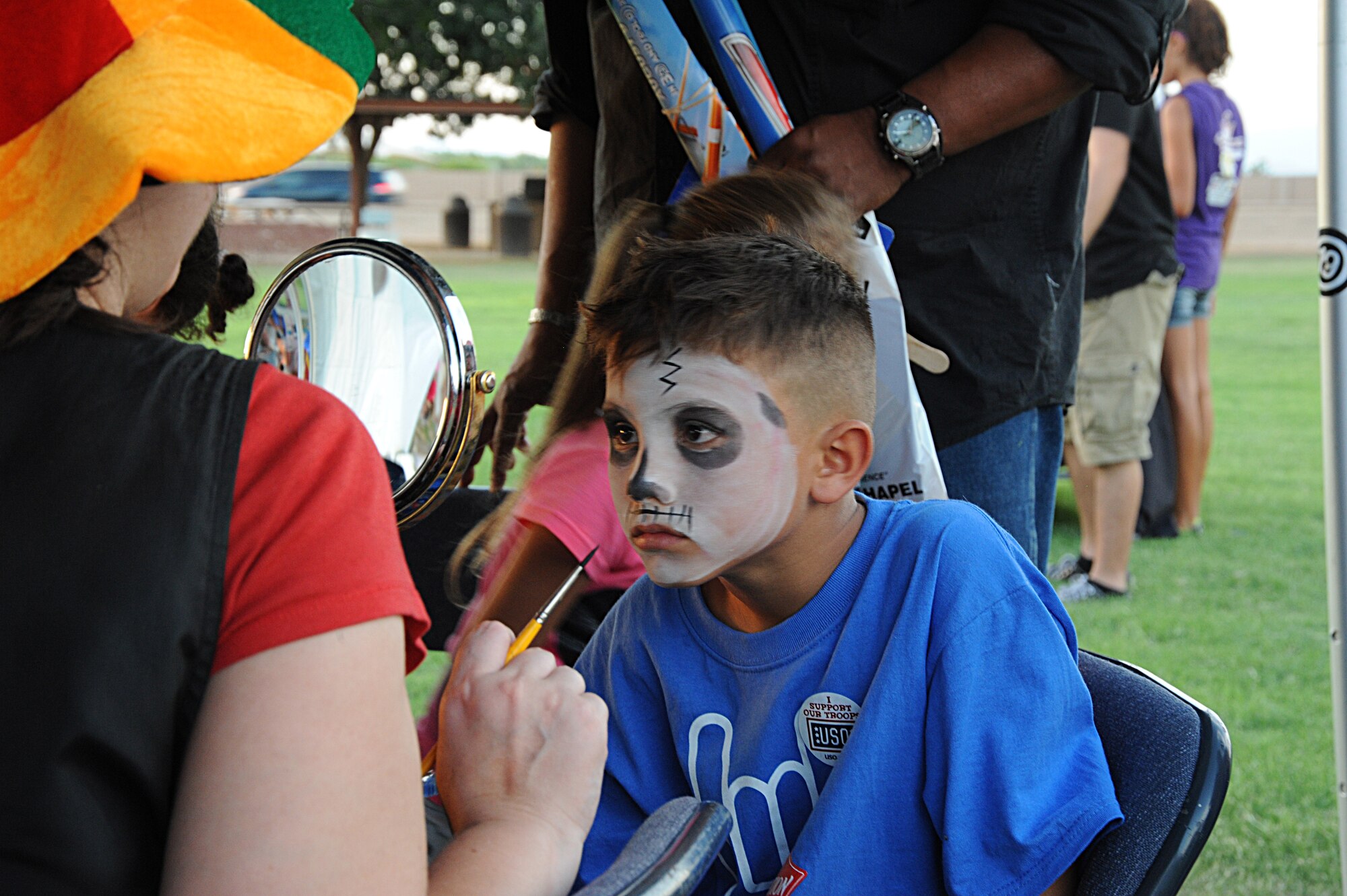 A Luke family member gets his face painted during the the Back to School Bash Aug. 2 at Fowler Park on Luke Air Force Base. The event  was sponsored by the Luke Chapel to give back to the community as well as prepare children for the upcoming school year. More than 500 people came out for the event. (U.S. Air Force photo/Airman 1st Class Pedro Mota)