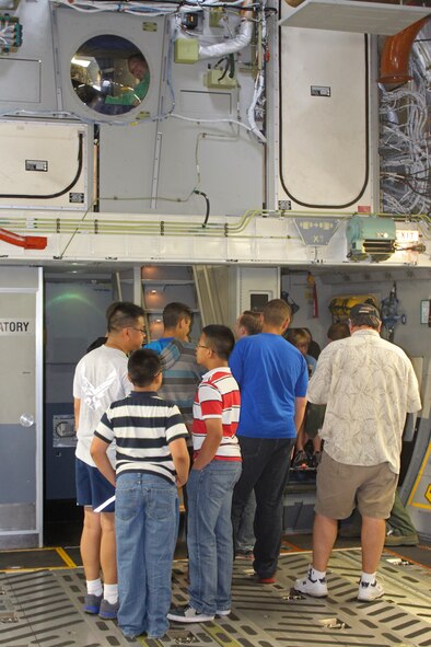 Members of the 446th Airlift Wing, along with their family members, tour a C-17 Globemaster III on McChord Field, Wash., as part of the wing's Reserve Family Symposium Aug. 10. This is the first year for the event and more than 500 people attended. (U.S. Air Force Reserve Photo/Staff Sgt. Rachael Garneau)