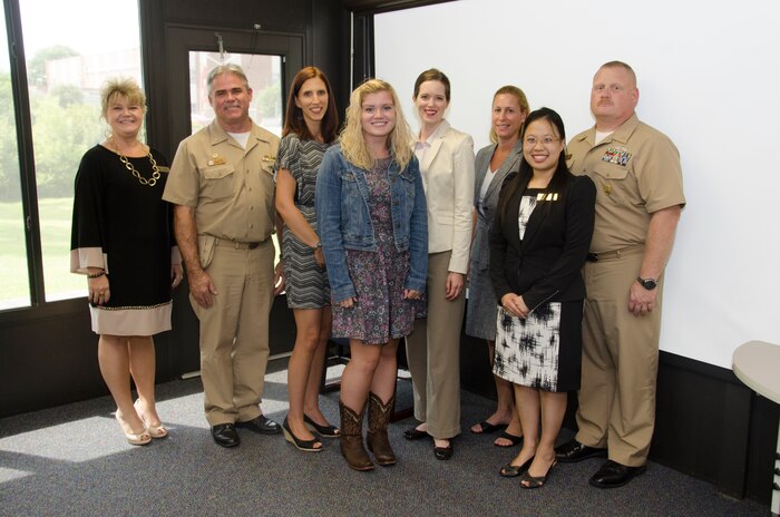 JOINT BASE CHARLESTON - WEAPONS STATION, S.C. — Kimberly Brown, Fleet and Family Support Center (left), Naval Support Activity Charleston Commanding Officer Capt. Timothy Sparks, Suerjee Lee, FFSC (second from right) and NSA Charleston Command Master Chief Joseph Gardner commend the recent group who completed the local FFSC Ombudsman training.  (Ffrom inside left ): Stephanie Weddell, Navy Munitions Command Unit Charleston; Brooke Johnson, Navy Operational Support Center Charleston; Elizabeth Cole and Sharon Schmelling, Naval Consolidated Brig Charleston. Ombusdman serve as liaisons between command leadership and a Sailor’s family members, often being the ones relied upon to communicate difficult messages or be a first line referral resource when Sailors are deployed. (U.S. Navy photo/ Petty Officer 1st Class Chad Hallford) 

