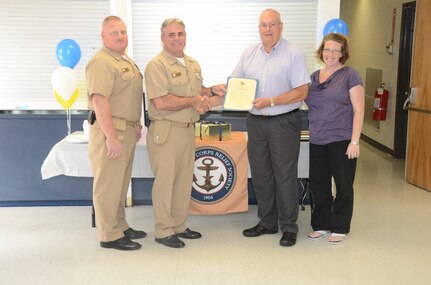 JOINT BASE CHARLESTON - WEAPONS STATION, S.C. — Naval Support Activity Charleston’s Commanding Officer Capt. Timothy Sparks, Command Master Chief Joseph Gardner and incoming Navy-Marine Corps Relief Society director, Tiffany Gavazzo present a certificate of appreciation to retiring Charleston NMCRS director David Hastings July 29, 2013. Hastings leaves the society after 30 years of service to Sailors, Marines, retirees and their family members. (U.S. Navy photo/ Petty Officer 1st Class Chad Hallford) 