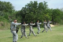 902nd Security Forces Squadron members participate in a "shoot, move and communicate" training drill at Joint Base San Antonio-Randolph's Camp Talon July 24. During classroom lessons followed by practical application,
defenders were able to increase their proficiency in battlefield conditions. (U.S. Air Force photo by Rich McFadden/released)