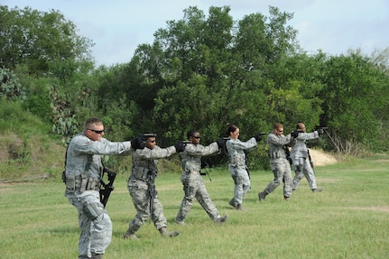902nd Security Forces Squadron members participate in a "shoot, move and communicate" training drill at Joint Base San Antonio-Randolph's Camp Talon July 24. During classroom lessons followed by practical application,
defenders were able to increase their proficiency in battlefield conditions. (U.S. Air Force photo by Rich McFadden/released)