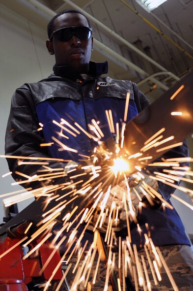 U.S. Air Force Airman 1st Class Jonathan Brown, 35th Maintenance Squadron, uses a blowtorch to cut through steel used on F-16 Fighting Falcons at Misawa Air Base, Japan, Aug. 8, 2013. Brown is a metals technologist who specializes in machine welding and aircraft part fabrication. (U.S. Air Force photo/Senior Airman Derek VanHorn)