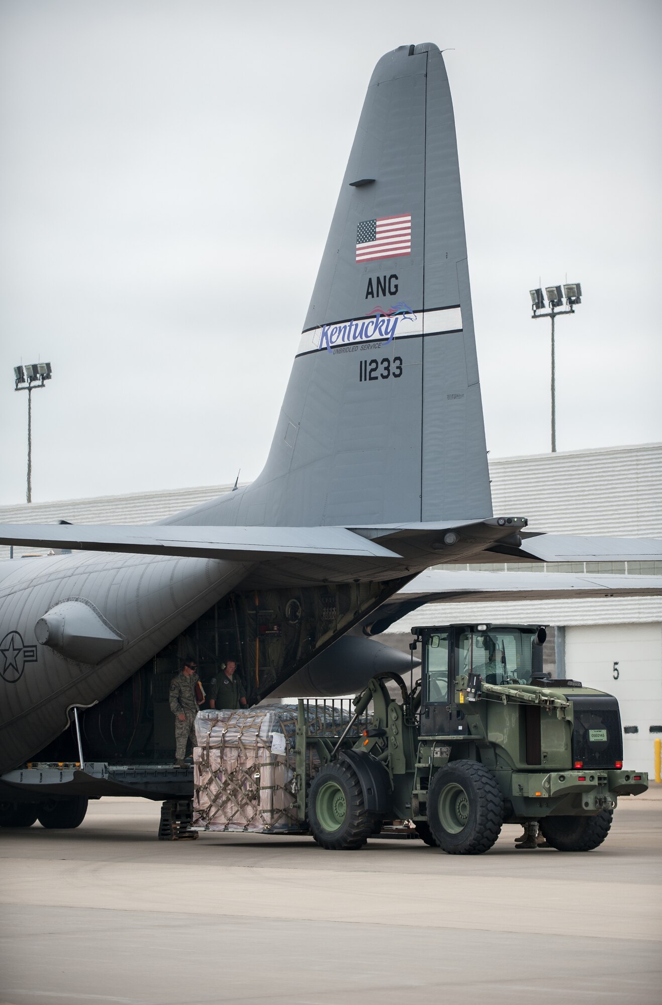 Airmen from the Kentucky Air National Guard’s 123rd Contingency Response Group offload equipment from a C-130 Hercules aircraft at MidAmerica St. Louis Airport in Mascoutah, Ill., on Aug. 5, 2013, as part of Exercise Gateway Relief, a U.S. Transportation Command-directed earthquake-response scenario. The 123rd is joining forces with the U.S. Army’s active-duty 689th Rapid Port Opening Element from Fort Eustis, Va., to stand up and operate a Joint Task Force-Port Opening, which combines an Air Force Aerial Port of Debarkation with an Army trucking and distribution unit. The aerial port ensures the smooth flow of cargo and relief supplies into affected areas by airlift, while the trucking unit facilitates their final distribution over land. (U.S. Air National Guard photo by Maj. Dale Greer)