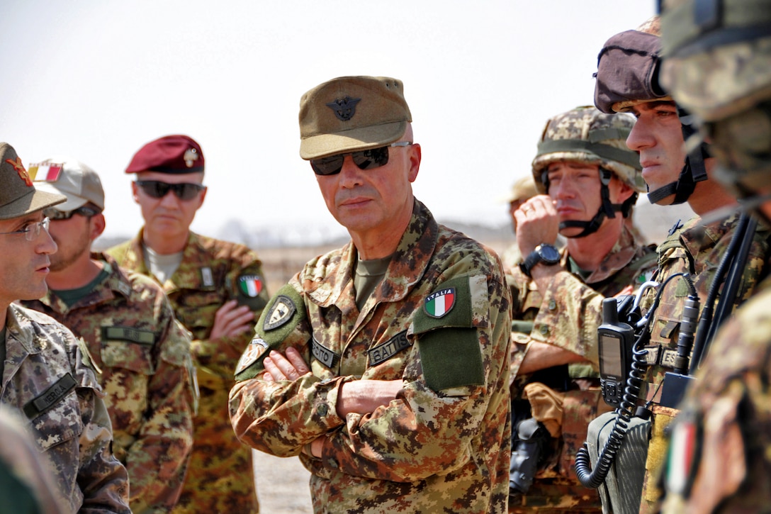 Italian army Lt. Gen. Giorgio Battisti, center, chief of staff for the International Security Assistance Force, observes a demonstration during his visit to Forward Operating Base Farah, Afghanistan, Aug. 8, 2013. The soldiers are assigned to Company C, 1st Squadron, 168th General Support Aviation Battalion. U.S. soldiers and members of Transition Support Unit South participated in the demonstration, focusing on route clearing and medical evacuation.