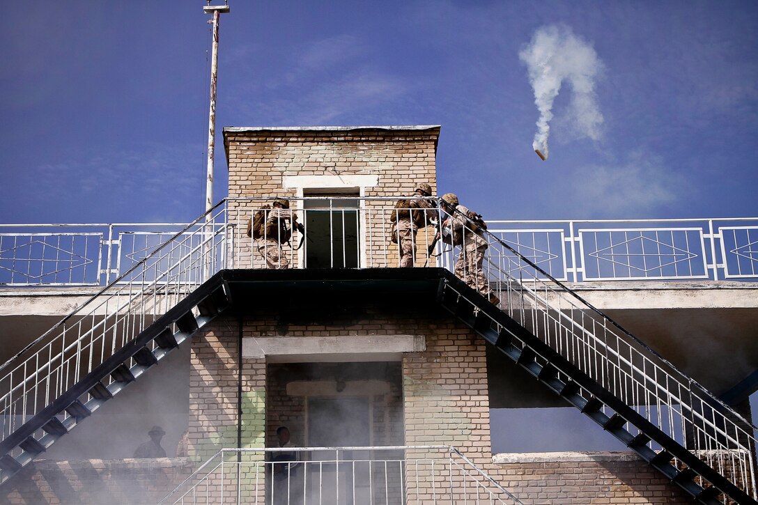 U.S. Marines clear a building during a cordon and search event during Khaan Quest 2013 at Five Hills Training Area in Mongolia, Aug. 08, 2013.