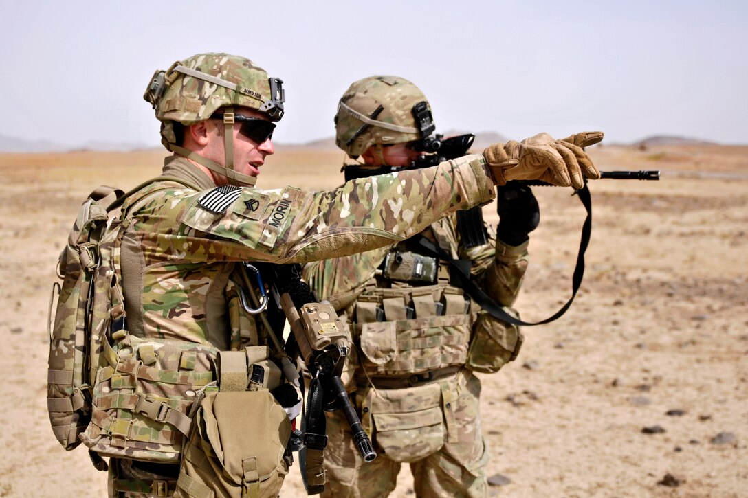 U.S. Army Staff Sgt. Matthew Morin, left, points as U.S. Army 2nd Lt. Doug Palmer, right, scans a culvert for improvised explosive devices in Kandahar province, Afghanistan, Aug. 7, 2013. Morin and Palmer are assigned to Engineer Troop, Regimental Support Squadron, Combined Task Force Dragoon.