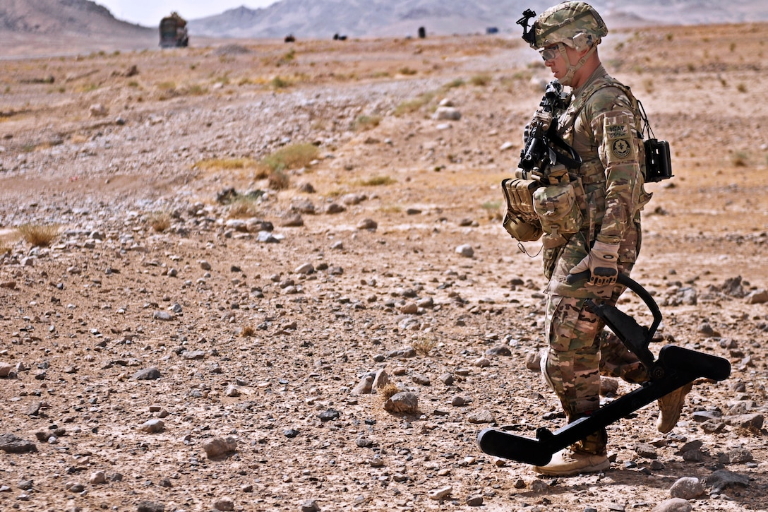 A U.S. soldier uses a lightweight, portable, handheld device called a goldie to detect improvised explosive devices in Kandahar province, Afghanistan, Aug. 7, 2013.