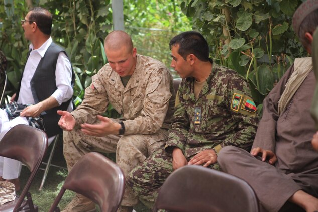Marine Lt. Geoffrey Marshall, the logistics officer with the Regional Corps Battle School, talks with an Afghan National Army soldier with the Regional Corps Training Center here during an Eid al-Fitr celebration. The beginning of Eid marks the end of Ramadan, the Islamic holy month observed by Muslims around the world. “It takes a long time to develop effective relationships with your counterparts,” said Maj. Aron M. Axe, the RCBS operations officer. “You have to sit down and invest time with your counterparts to understand them and allow them to understand you.”