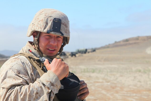 First Lt. William Tuhacek, a communications officer with Headquarters and Support Company, Combat Logistics Battalion 5, Combat Logistics Regiment 1, 1st Marine Logistics Group, signals to a motor transportation convoy during a communications exercise aboard Camp Pendleton, Calif., July 25, 2013. Thirty-six Marines in the battalion conducted communication operations while in the field. Marines trained in wire, radio and data capabilities alongside motor transportation Marines to ensure Marines within CLB-5 were proficient in their techniques, tactics and procedures.