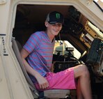 Austin Saxton smiles excitedly at his dad from the inside of a Mine-Resistant Ambush Protected All-Terrain Vehicle aboard Camp Lejeune, N.C., Aug. 02. 2013. Austin was a Marine for the day and got VIP treatment from Capt. Lee Stuckey, the company commander for Transportation and Support Company, Combat Logistics Battalion 2, 2nd Marine Logistics Group. (U.S. Marine Corps photo by Cpl. Devin Nichols)