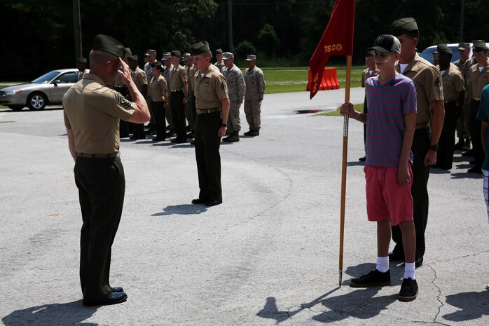 The company first sergeant of Transportation and Support Company, Combat Logistics Battalion 2, 2nd Marine Logistics Group, salutes Austin Saxton, who was the acting company commander for the day aboard Camp Lejeune, N.C., Aug. 02, 2013. Capt. Lee Stuckey, the company commander for T & S Co., arranged for Austin to tour the base as well as enjoy other activities after hearing about his courageous fight with Cancer. (U.S. Marine Corps photo by Cpl. Devin Nichols)