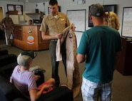 A Marine officer issues Austin Saxton an authentic flight suit and patches during his visit to Marine Corps Air Station New River Aug. 02, 2013. Austin’s visit was made possible by Capt. Lee Stuckey, the company commander for Transportation and Support Company, Combat Logistics Battalion 2, 2nd Marine Logistics Group aboard Camp Lejeune, N.C. (U.S. Marine Corps photo by Cpl. Devin Nichols)