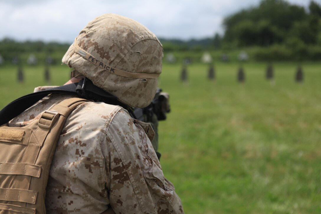 Lance Cpl. Christopher Petrick of 1st Platoon, Company G, 2nd Battalion, 24th Marine Regiment sends rounds downrange during a round of rifle qualifications at Camp Atterbury, Ind., Aug. 9. Both Co. G from Madison, Wis. and Co. F from Milwaukee, Wis. travelled to Camp Atterbury as part of their required rifle qualifications. (U.S. Marine Corps photo by Lance Cpl. Tiffany Edwards)