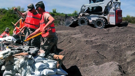 Missouri National Guard Soldiers with the 1140th Forward Support Company fill sandbags in Dutchtown, Mo.