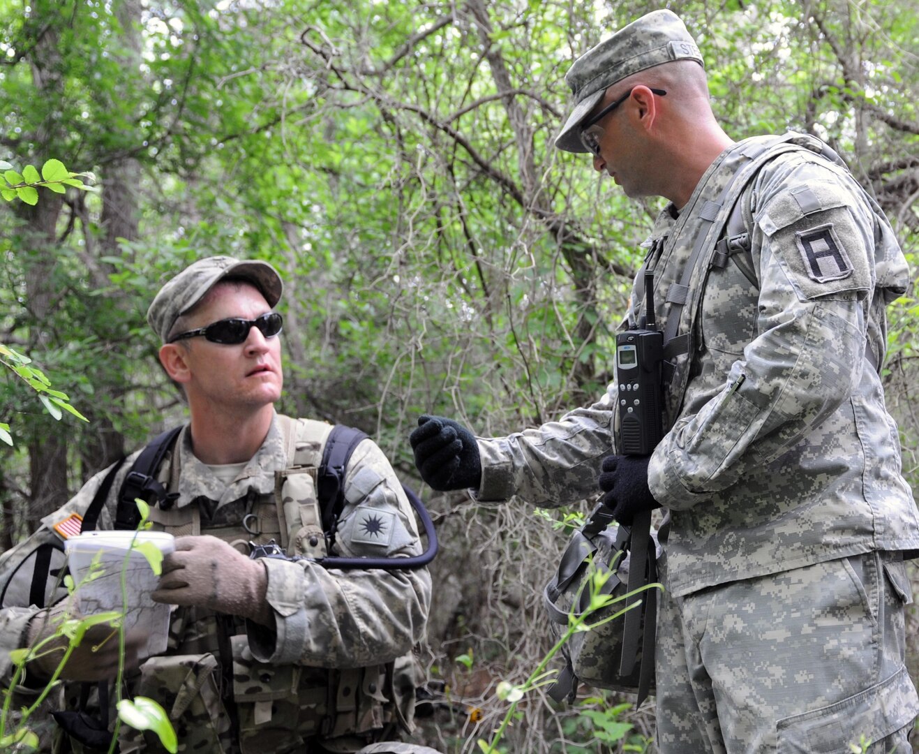 Sgt. 1st Class John Steffey provides Team Leader 1st Lt. Servando Maldonado of the California National Guard with tactical feedback as they move through the personnel recovery lanes at North Fort Hood, Texas, April 17, 2013.