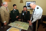 Maj. Gen. Raymond F. Rees, right, adjutant general, Oregon, and Lt. Gen. Tran Quang Khue discuss a map of Vietnam during the State Partnership Program Workshop, in Portland, Ore., April 19.