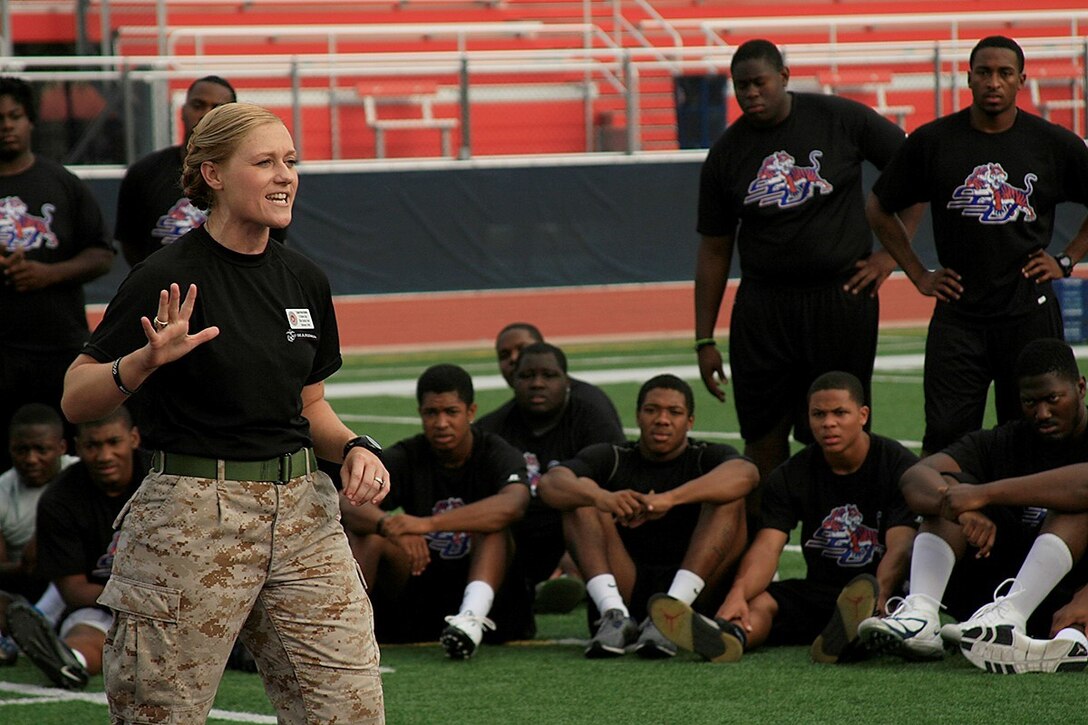 Captain Nicole Bastian, the Officer Selection Officer for Tallahassee, Fla., describes the events the student-athletes of the Savannah State University football team are about to partake in during a leadership exercise at the university’s football field in Savannah, Ga., Aug. 5, 2013. Marines and Officer Selection Officers from throughout the 6th District came to Savannah State University to help motivate, build comradery, and challenge the student-athletes during a leadership exercise and impart the Marine Corps values of honor, courage, and commitment on and off the field.