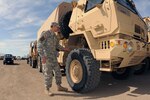 U.S. Army Sgt. Tobias Mathern, of the 815th Engineer Company (Horizontal), North Dakota Army National Guard, performs routine maintenance on a light medium tactical vehicle (LMTV) at a light quick reaction force (LQRF) team location at the Cass County Highway Department facility, West Fargo, N.D., April 29, 2013.
