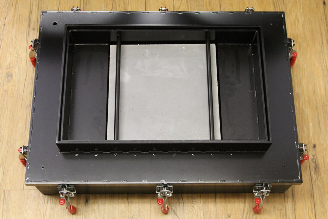 Scaled water chamber for characterizing concrete behavior under uniform pressure loadings such as those encountered in blast conditions.
