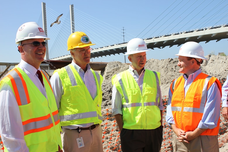 From right to left, U.S. Sen. Chris Coons, Del. Gov. Jack Markell, Tony Pratt, Delaware Shoreline Administrator and Curt Heckelman, Deputy for Programs and Project Management for the U.S. Army Corps of Engineers Philadelphia District, discuss the project at the north shore of the Indian River Inlet. USACE is helping restore the north shore by pumping more than half a million cubic yards of sand from the inlet and onto the beach. 